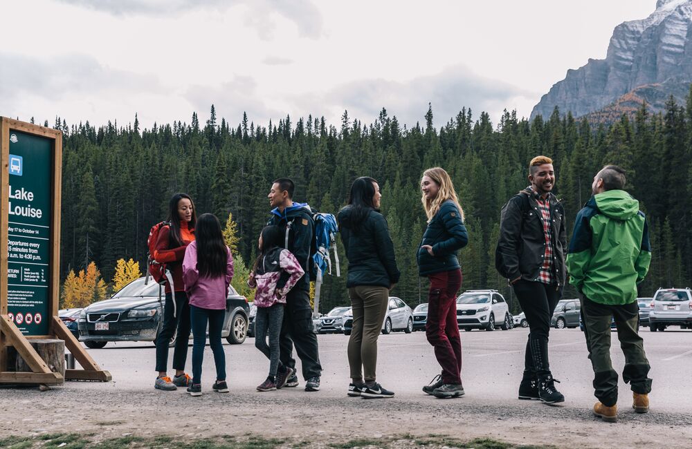 The passengers are waiting for a shuttle to come going to Lake Louise.